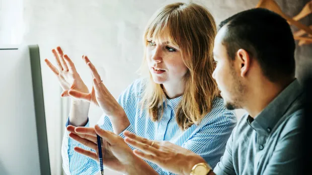 Man and woman talking using expressive hands