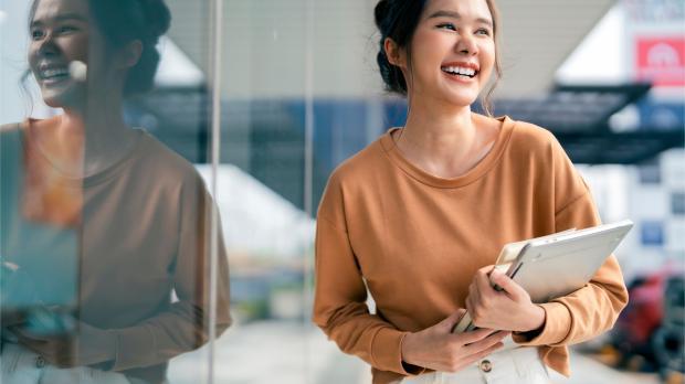 Smiling greeting cheerful asian teen woman