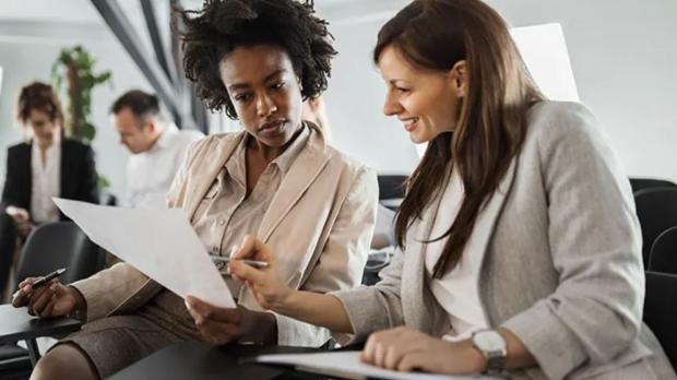 two women looking at documents