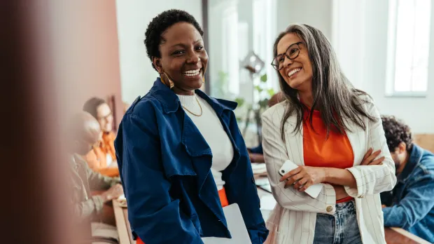 2 ladies at work smiling