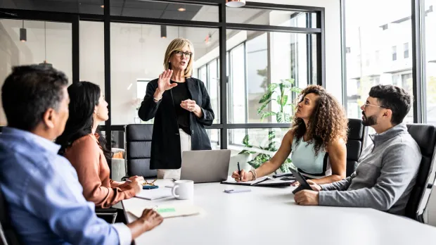 key people gathered around a business meeting table