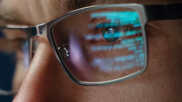 code reflected off glasses