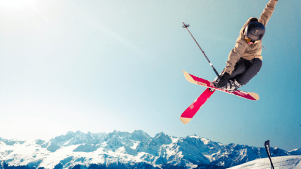 Man on skis jumping down mountain