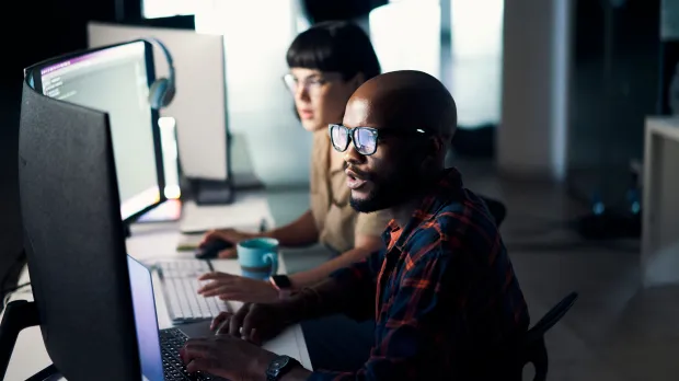 Two people working at computers