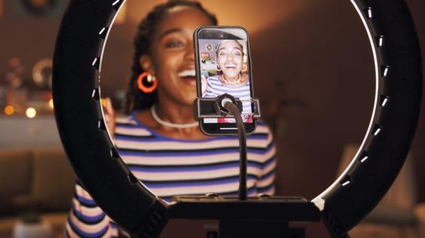 woman recording content with ring light