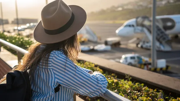 Airport: forward thinking Woman looking forward towards planes at an airport