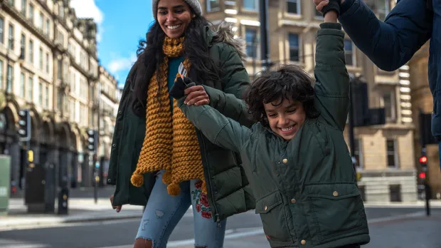 Flexible work life balance Family walking playfully in a street