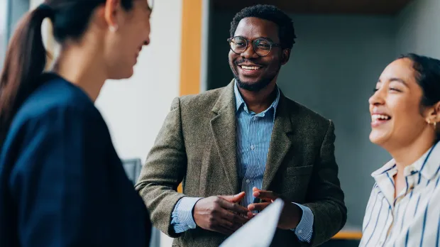 3 employees working together and laughing