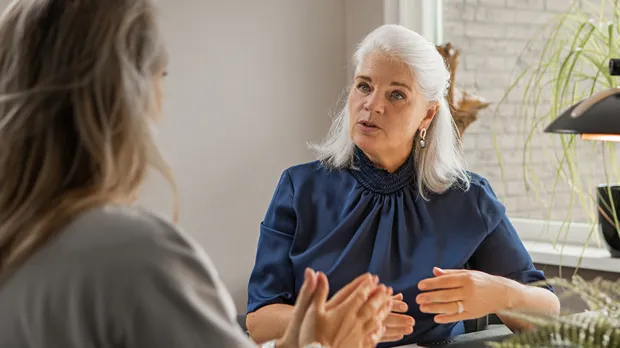 Two woman having intense discussion at a desk