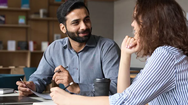Man and woman working together at a desk