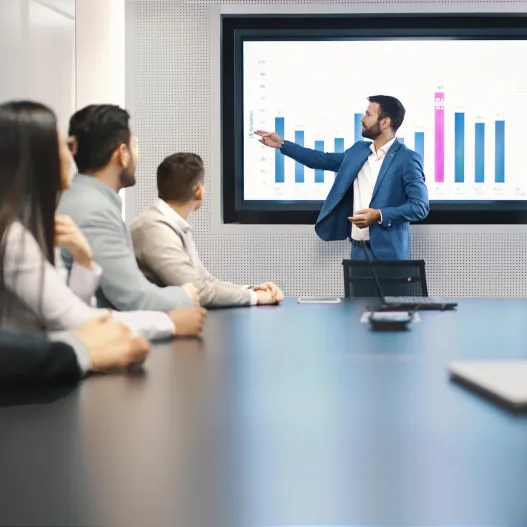 Financial presentation in board room with staff watching around the table