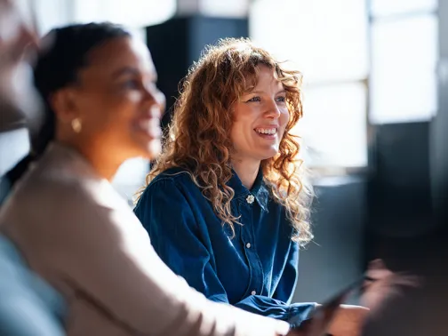 two women listening to work colleague