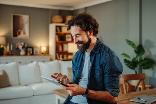Man looking down scrolling on tablet