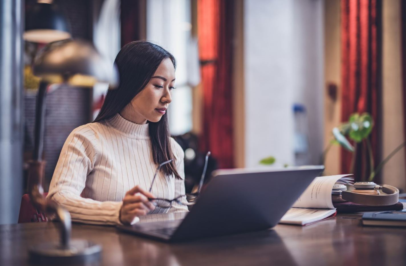 Woman at desk looking at laptop