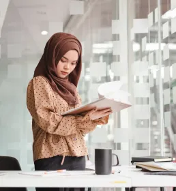 Young businesswoman reviewing documents in the office
