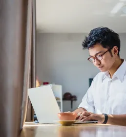 Business man infront of his laptop in cafe