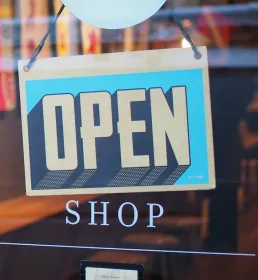 open sign on glass door of shop