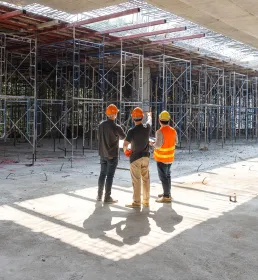 Three construction workers in a discussion