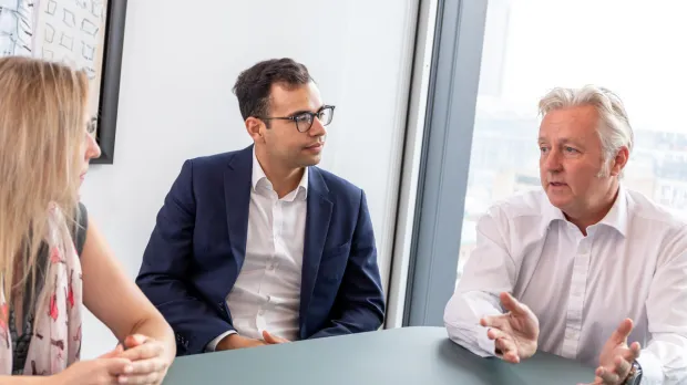 Brokers in deep discussion in a meeting