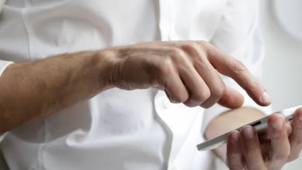 Man in a suit checking his phone