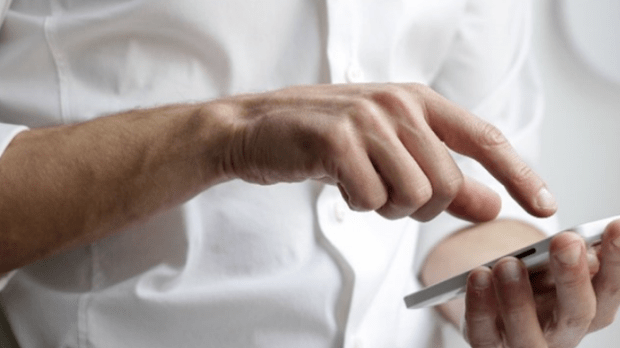 Man in a suit checking his phone