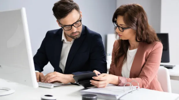 Two people looking over documents