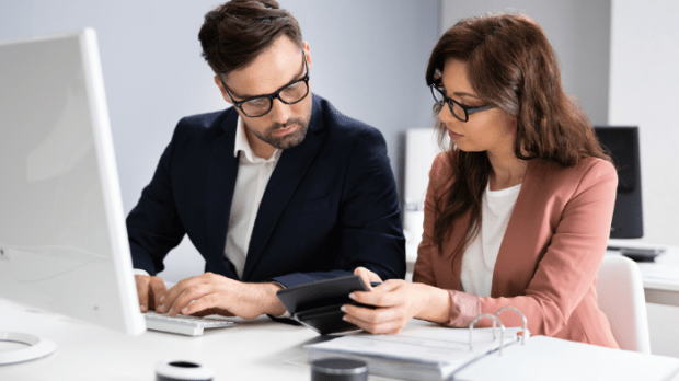 Two people looking over documents