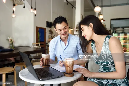 Two people having a business meeting over coffee