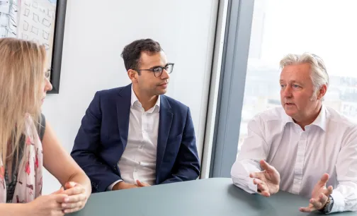 Brokers in deep discussion in a meeting