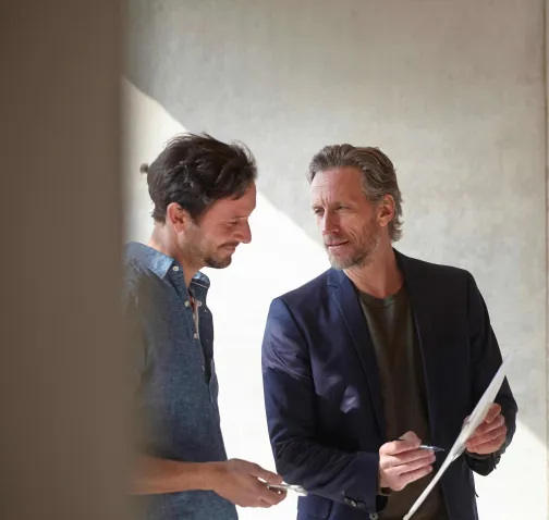Two business professionals discussing a construction plan