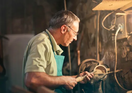 Carpenter working at night under a light