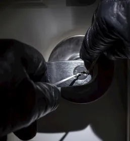 Criminal picking a lock