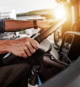 Driver at the wheel of a van at sunset