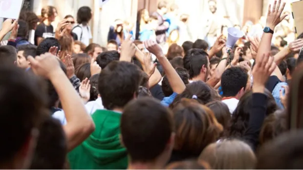 Political risk Image of a very crowded place and people having their hands raised