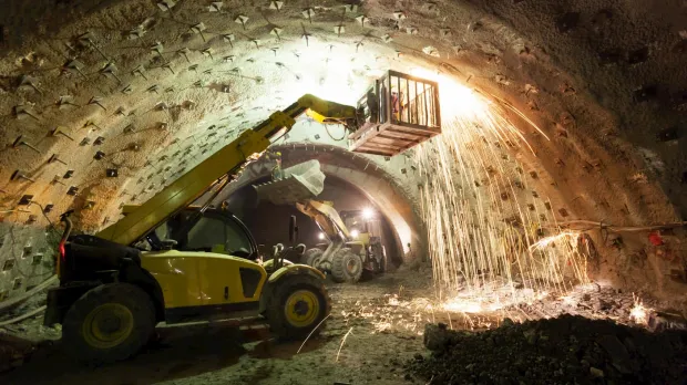 Cherry picker lift machine working in underground tunnel Cherry picker lift machine working in underground tunnel