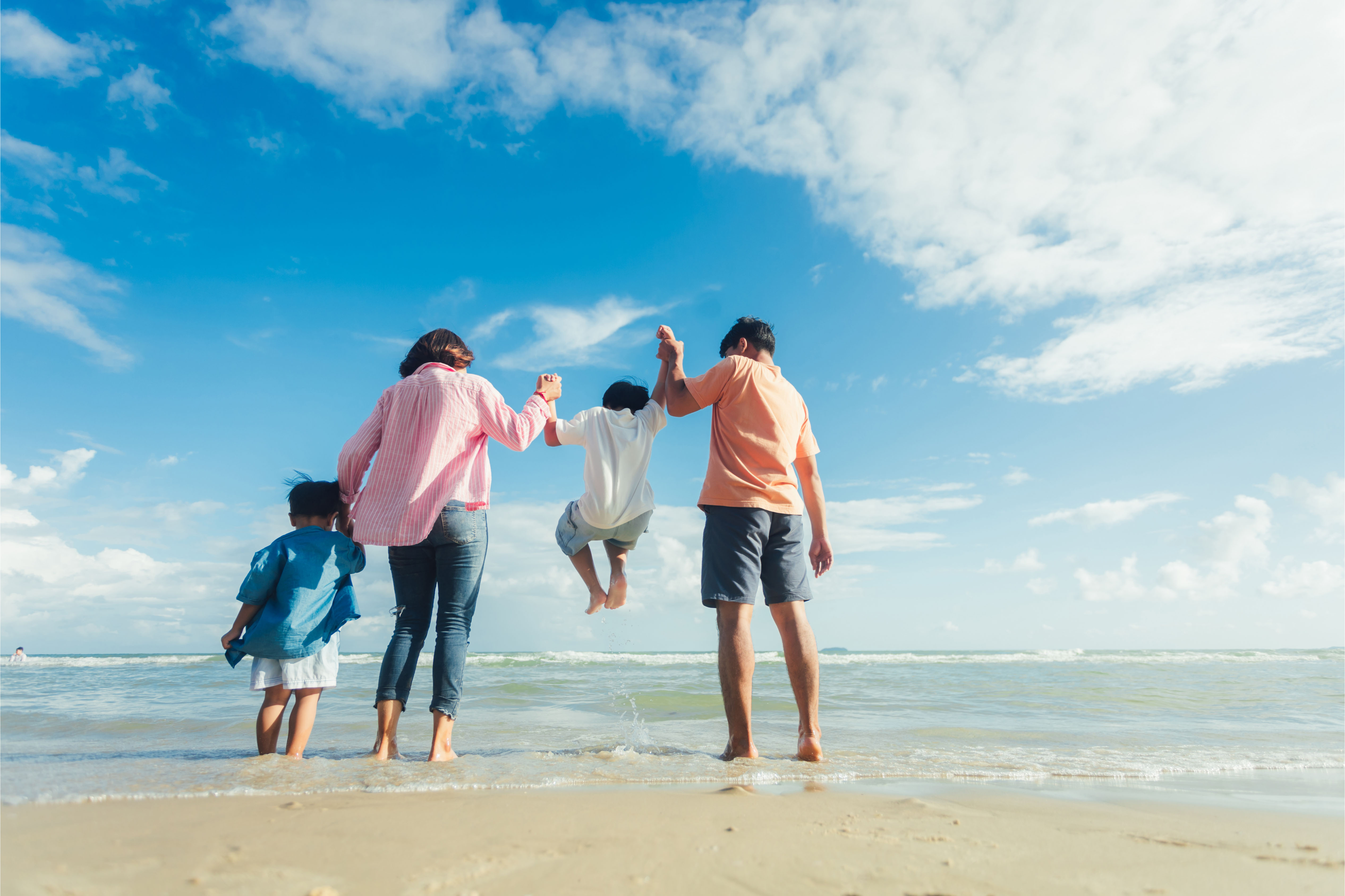 Happy young family Asian have fun on beach. Young family on vacation have a lot of fun
