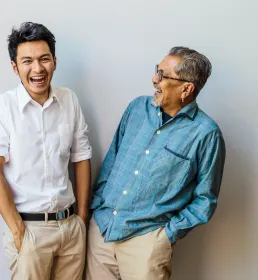 Father and son sharing a joke and laughing - Universal Life Insurance Howden Malaysia