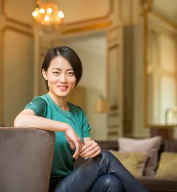 A wealthy woman in a plush hotel suite