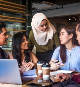 Muslim team leader encourage her team member during a business meeting