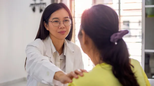 Doctor comforting female patient