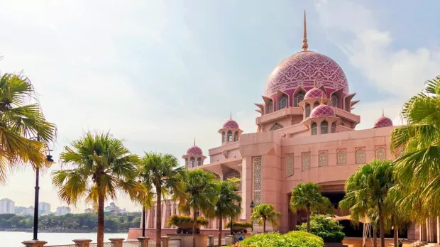 A beautiful mosque with palm trees leading up