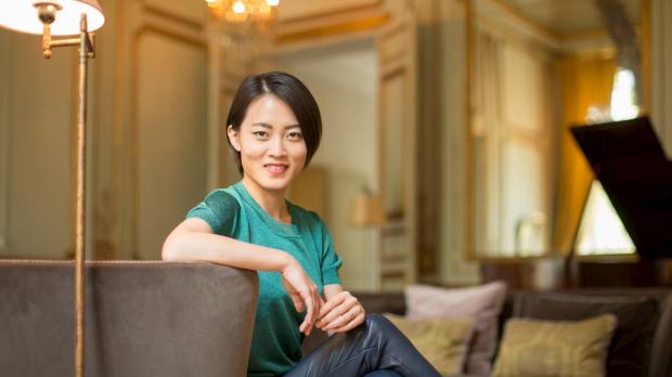 A wealthy woman in a plush hotel suite