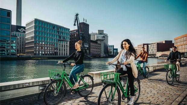 Group of Friends Riding a Bike Together
