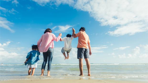 Happy young family Asian have fun on beach. Young family on vacation have a lot of fun