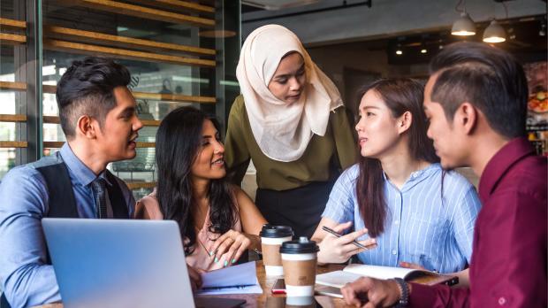 Muslim team leader encourage her team member during a business meeting