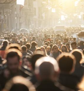 Hundreds of people walk in a crowded street in Thailand