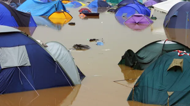 Event Cancellation Tents sit in deep muddy flood water
