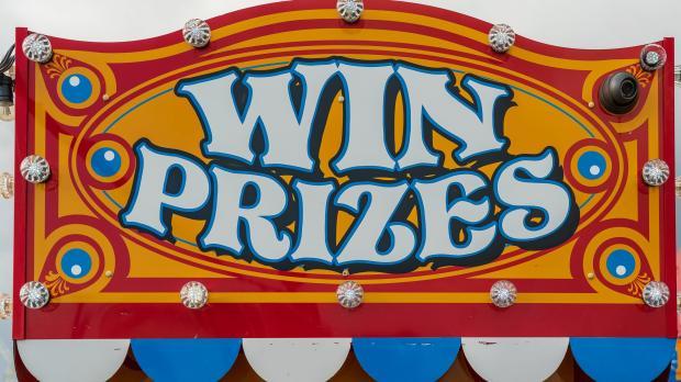 Colourful carnival sign which reads win prizes
