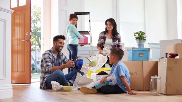 family moving into new home A family busy packing boxes getting ready to move into their new home