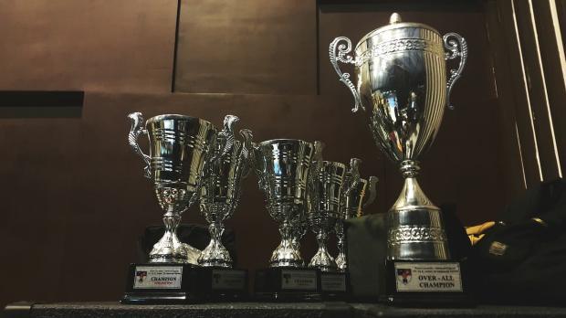 A collection of trophies sit on a shelf